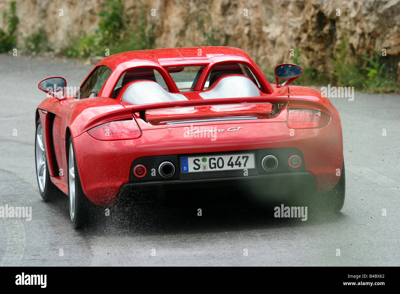 Car, Porsche Carrera GT, roadster, model year 2003-, Coupe/coupe, red,  driving, diagonal from the back, rear view, country road Stock Photo - Alamy