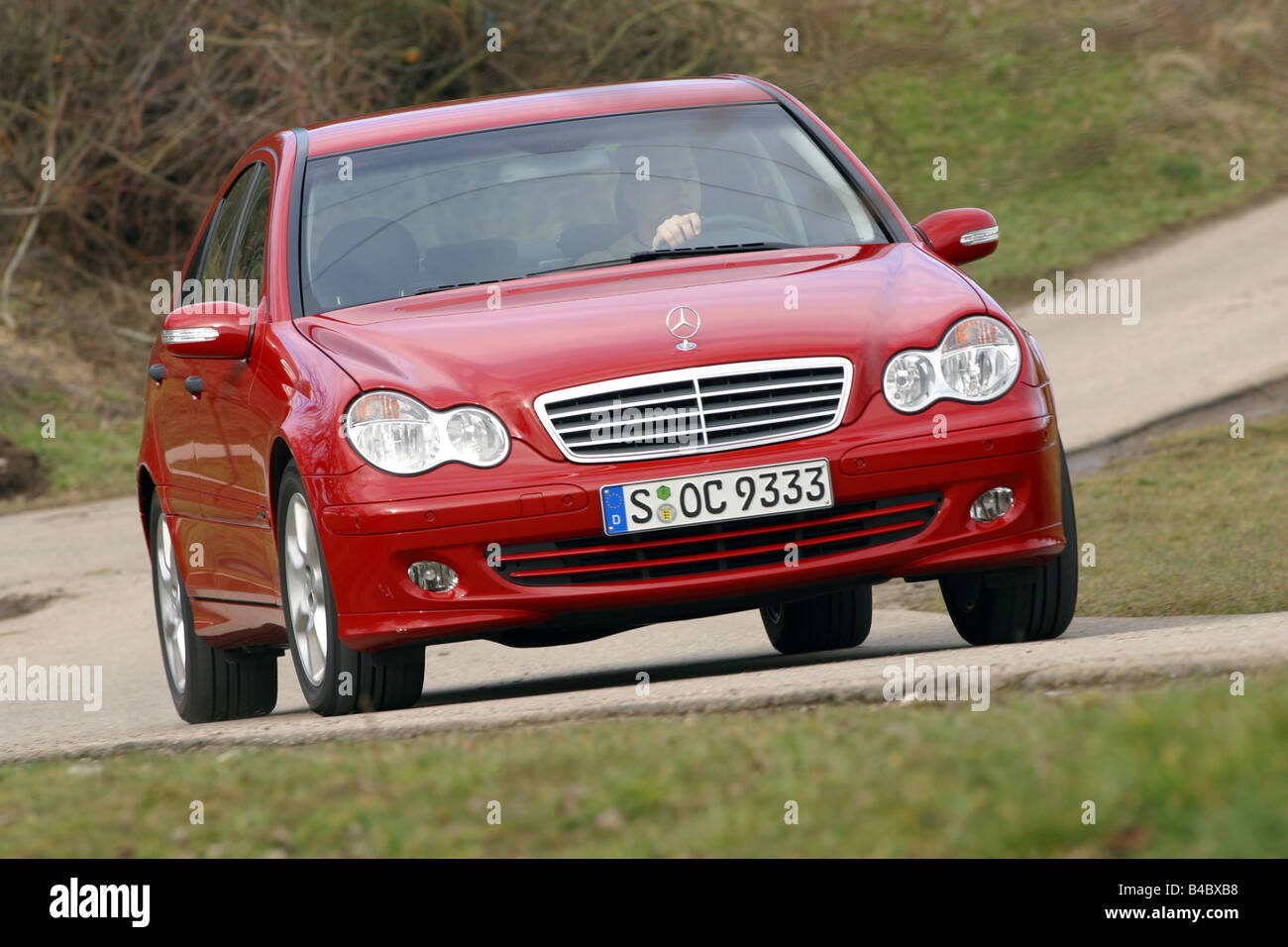 Car, Mercedes C 220 CDI, Limousine, medium class, model year 2004-, red, driving, diagonal from the front, frontal view, country Stock Photo