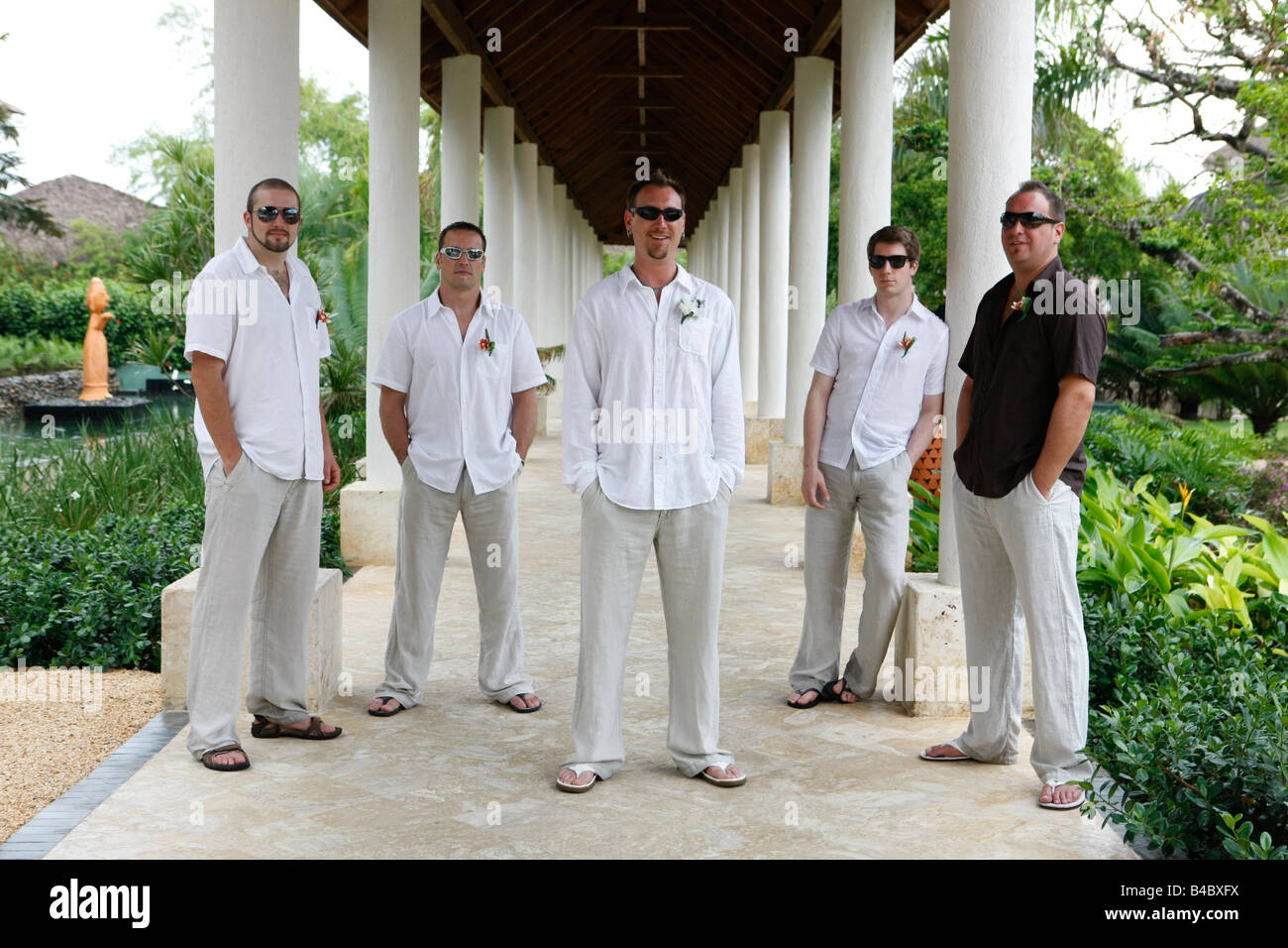 Groom And Groomsmen Posing For Photo At A Tropical Wedding At