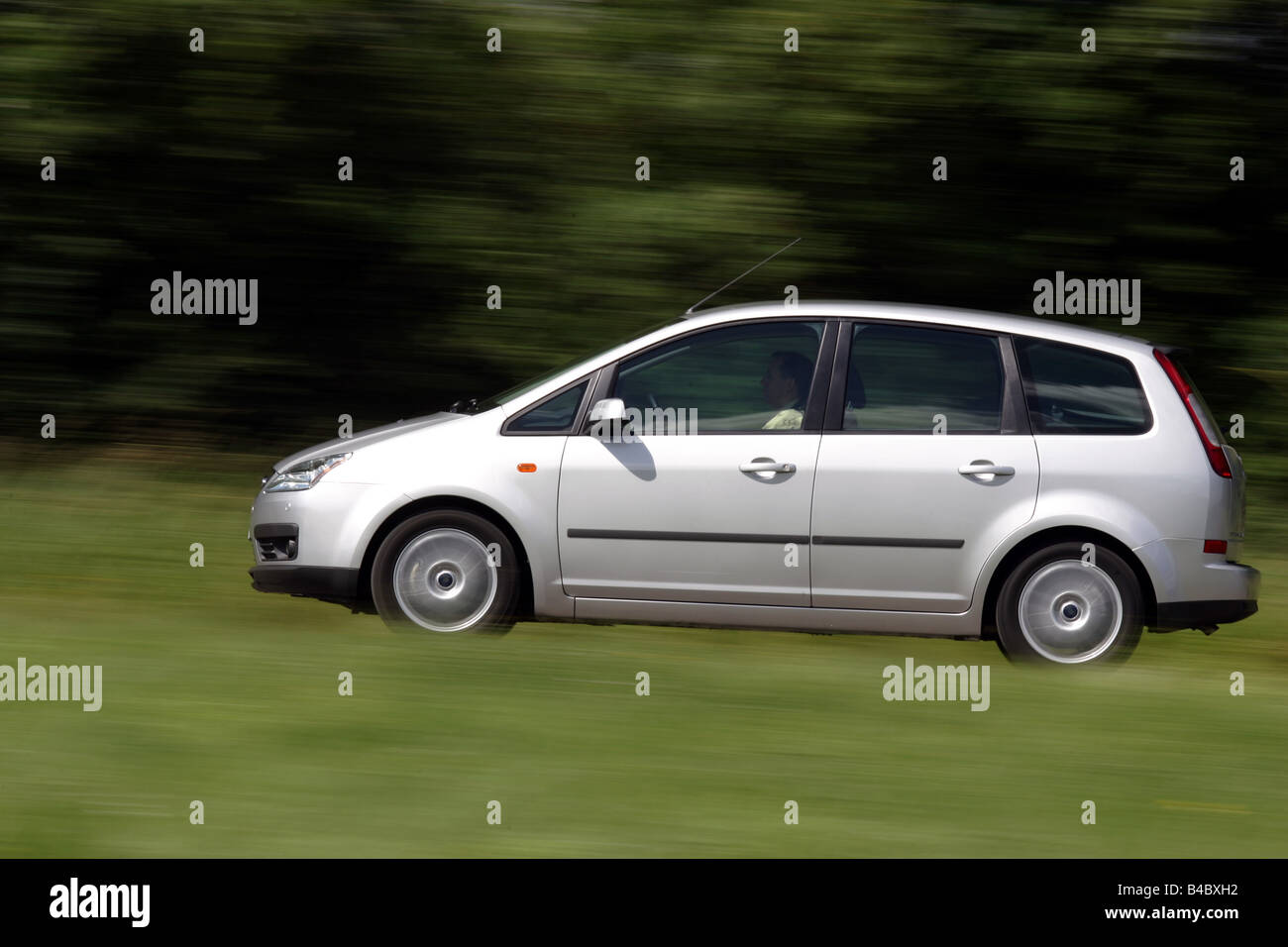 Car, Ford Focus C-Max, Limousine, Lower middle-sized class, model year 2003-, silver, driving, side view, country road, photogra Stock Photo