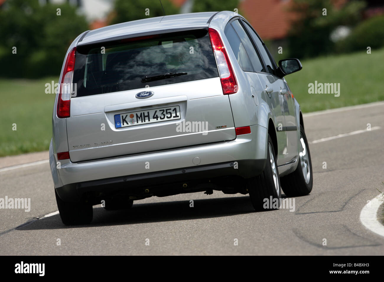 Car, Ford Focus C-Max, Limousine, Lower middle-sized class, model year 2003-, silver, driving, diagonal from the back, rear view Stock Photo