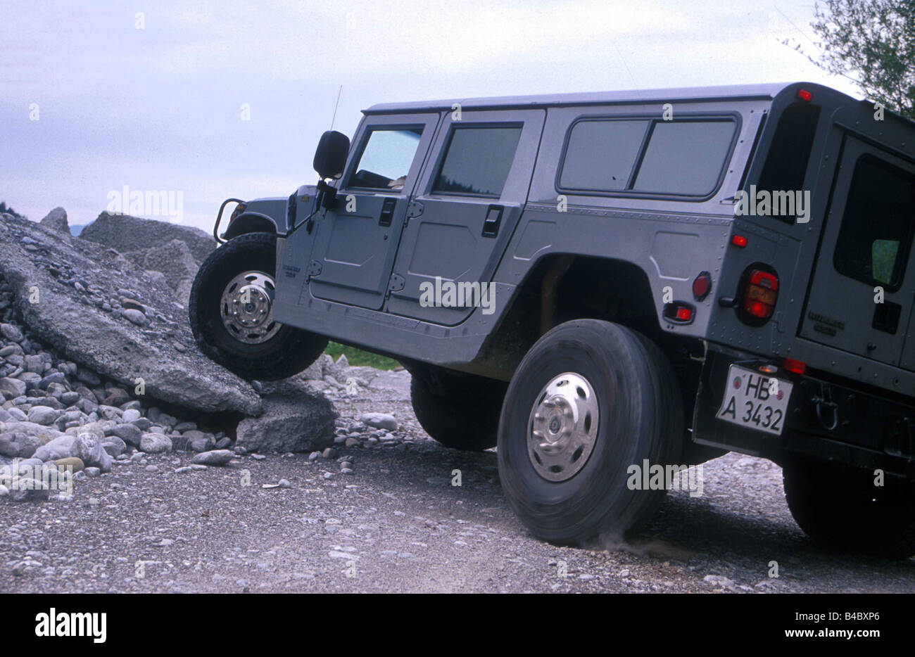 Car, Chevrolet Hummer 6.5L Impression, cross country vehicle, model year 1998-, gray, diagonal from the back, side view, driving Stock Photo