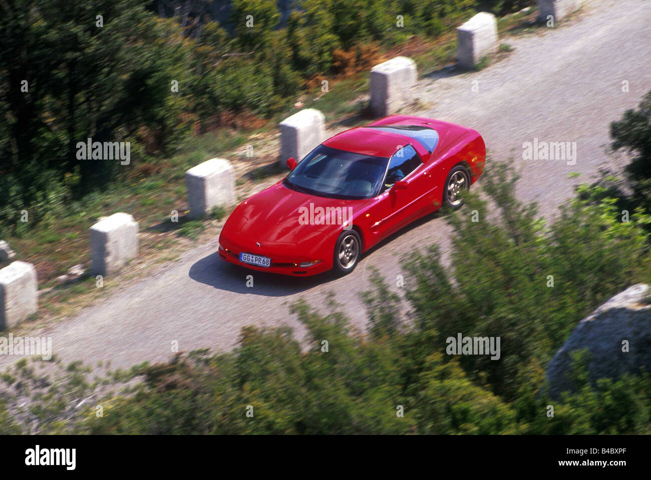 Car, Chevrolet Corvette coupe, roadster, model year 1998-, red, driving, diagonal from above/vorne, country road Stock Photo