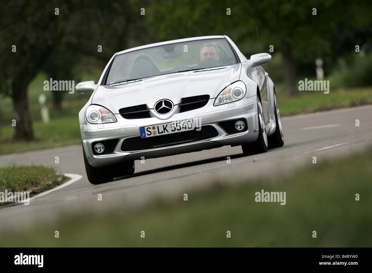 Car, Mercedes SLK 55 AMG, Convertible, model year 2004-, silver, open top, driving, diagonal from the front, frontal view, count Stock Photo