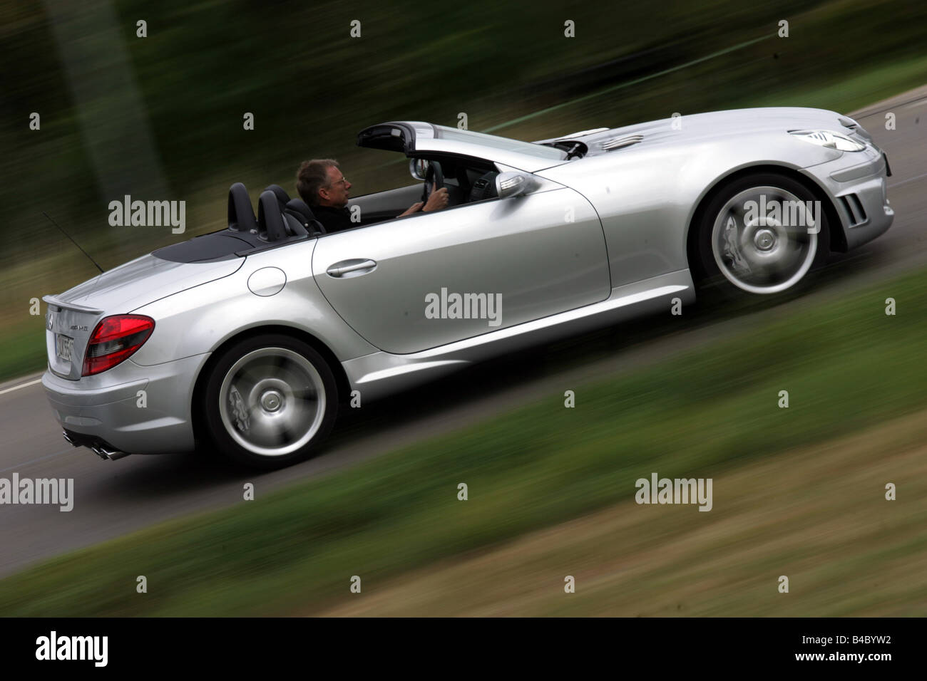 Car, Mercedes SLK 55 AMG, Convertible, model year 2004-, silver, open top, driving, side view, country road, photographer: Uli J Stock Photo