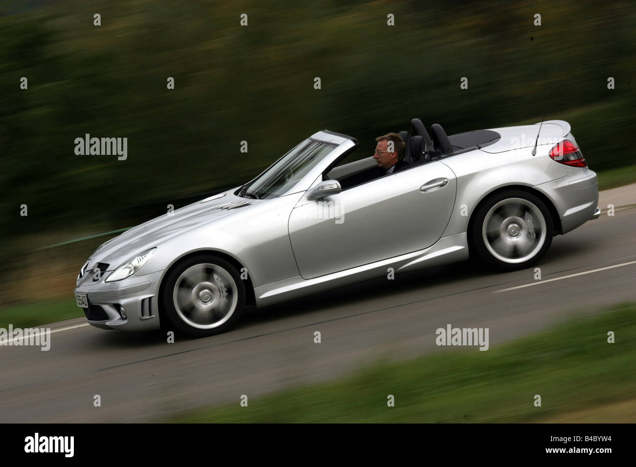 Car, Mercedes SLK 55 AMG, Convertible, model year 2004-, silver, open top, driving, side view, country road, photographer: Uli J Stock Photo