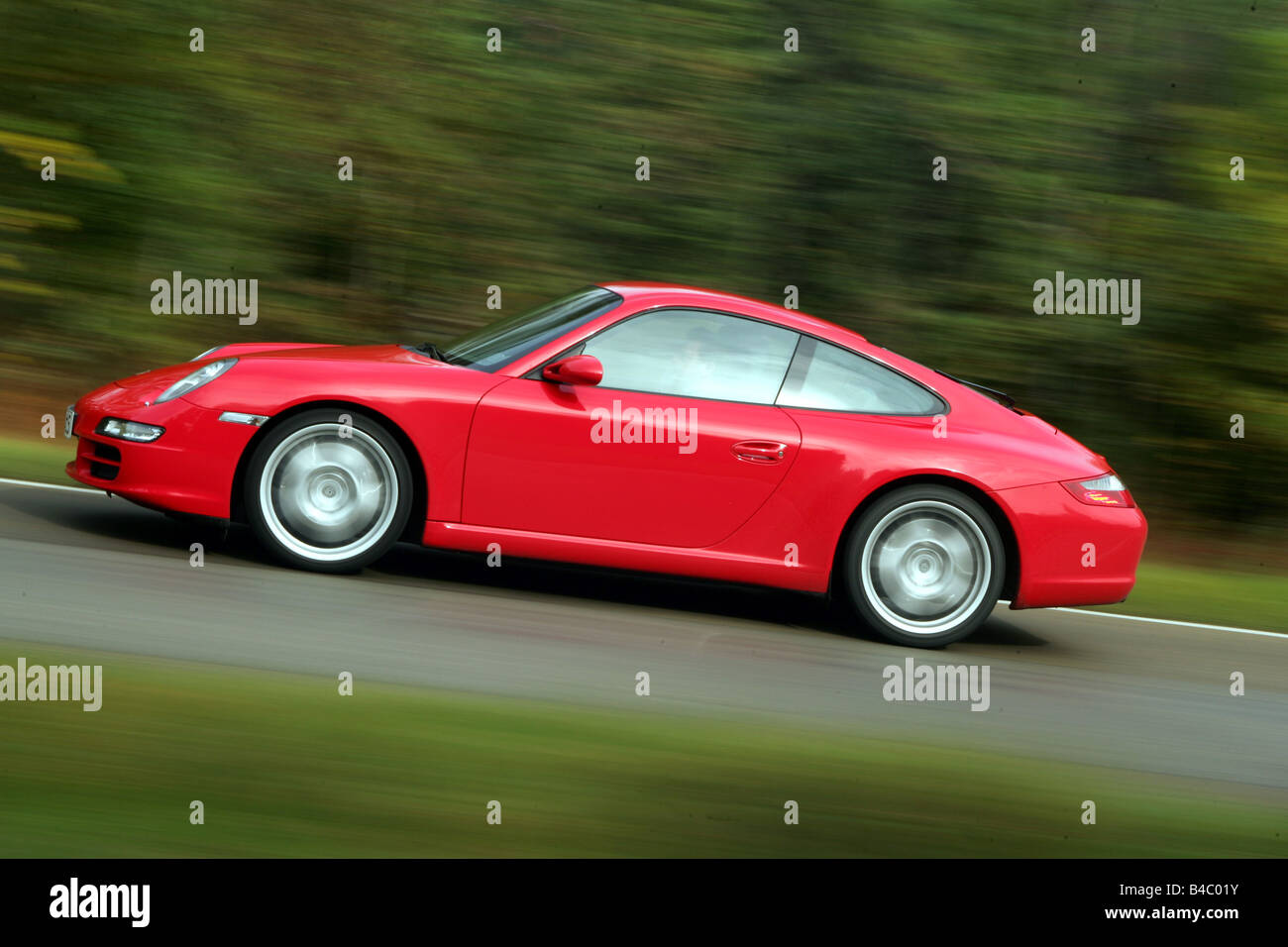 Car, Porsche 911 Carrera, model year 2004-, red, roadster, coupe/Coupe, driving, side view, country road, photographer: Hans Die Stock Photo