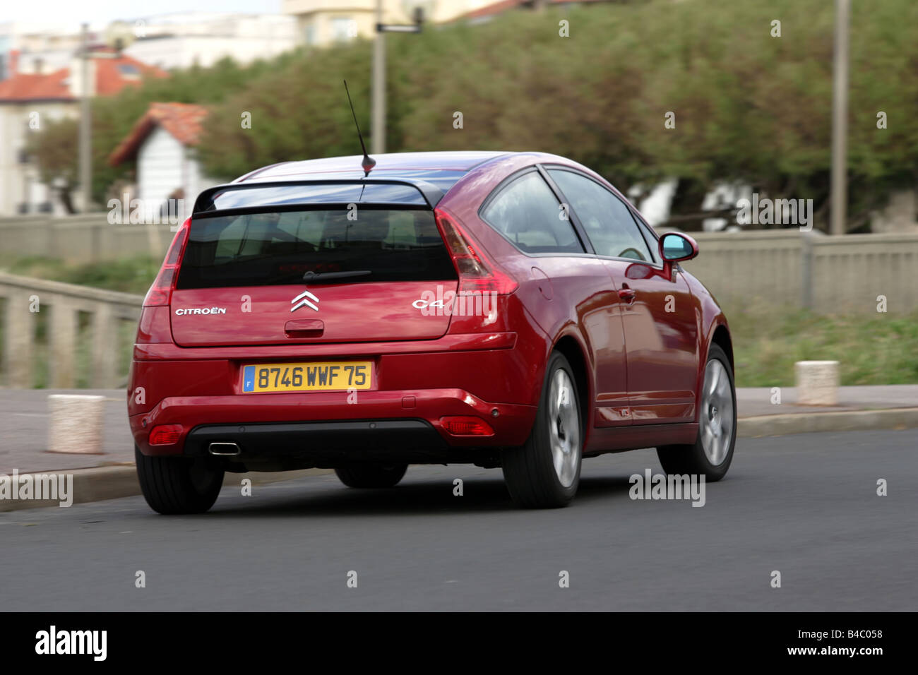 Car, Citroen C4, model year 2004-, Lower middle-sized class, coupe/Coupe,  ruby colored, driving, diagonal from the back, rear vi Stock Photo - Alamy