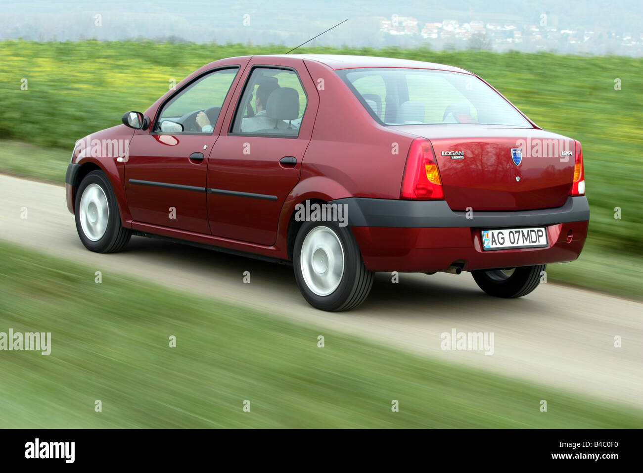 Car, Dacia Logan, model year 2004-, Limousine, Lower middle-sized class, red,  driving, diagonal from the back, rear view, side v Stock Photo - Alamy