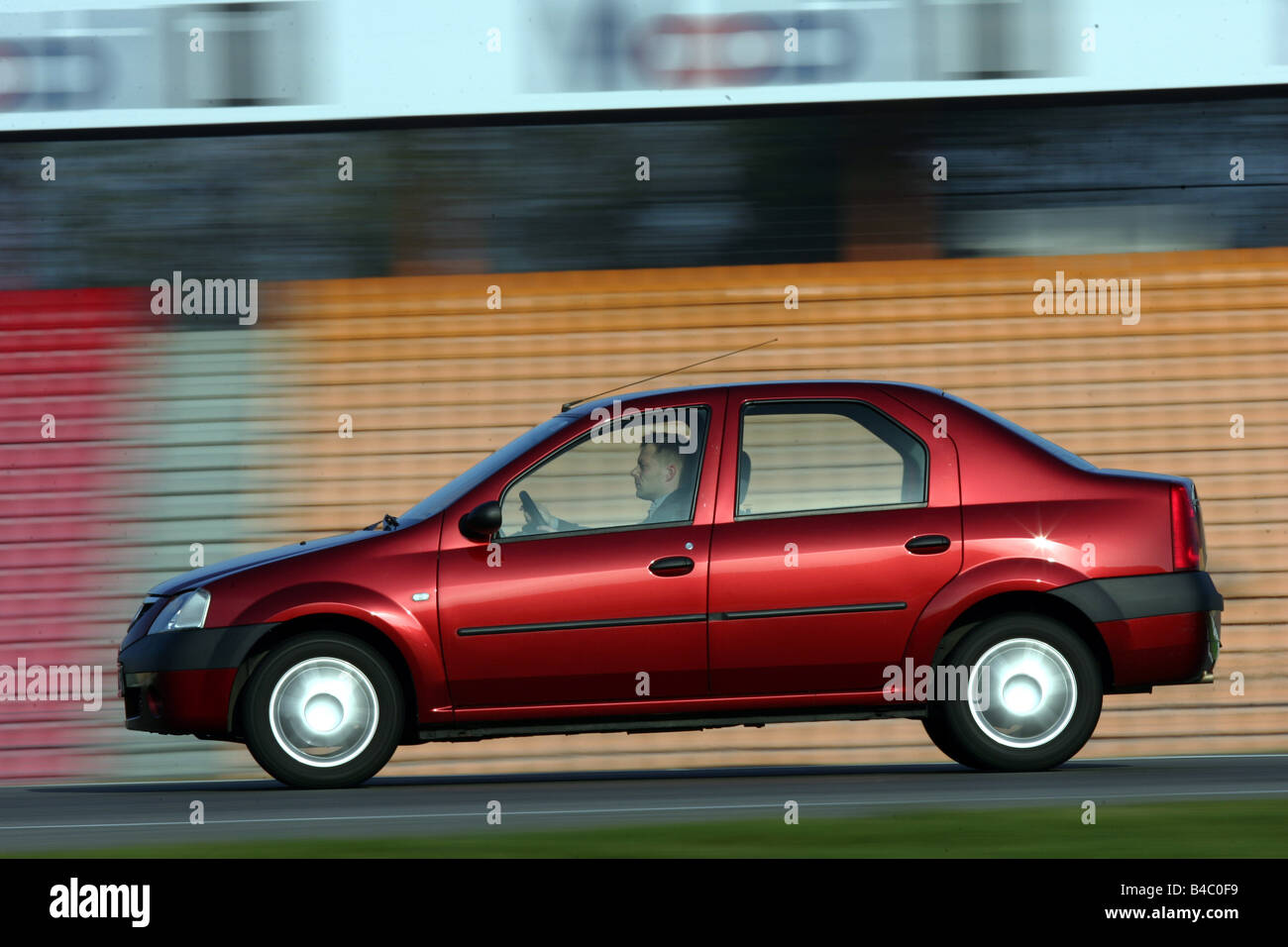 Car, Dacia model year 2004-, Limousine, middle-sized class, red, driving, side view, test track, Achi Stock Photo - Alamy