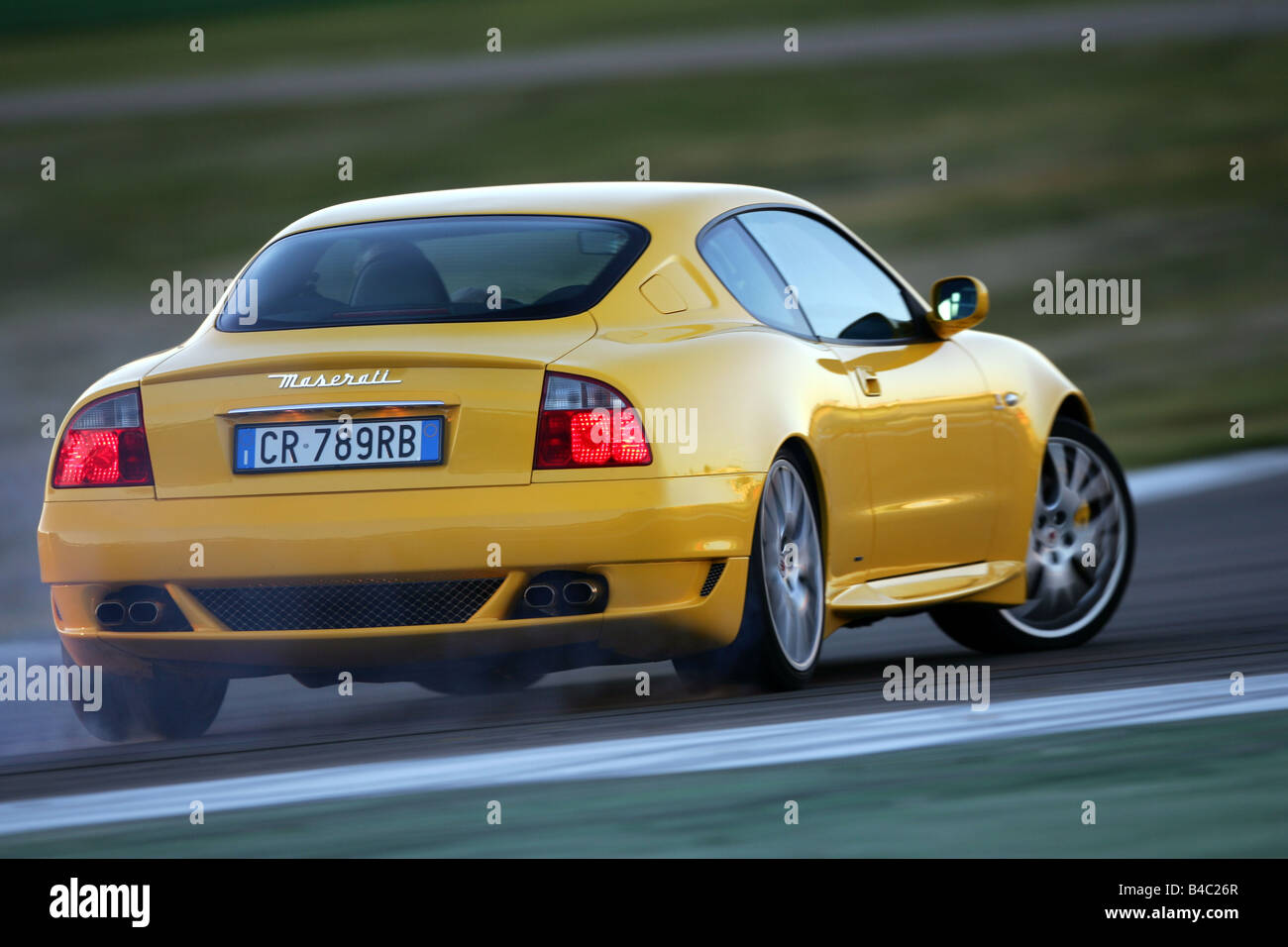 Car, Maserati Gransport V8, model year 2004-, yellow, roadster,  Coupe/coupe, driving, diagonal from the back, rear view, test tr Stock  Photo - Alamy