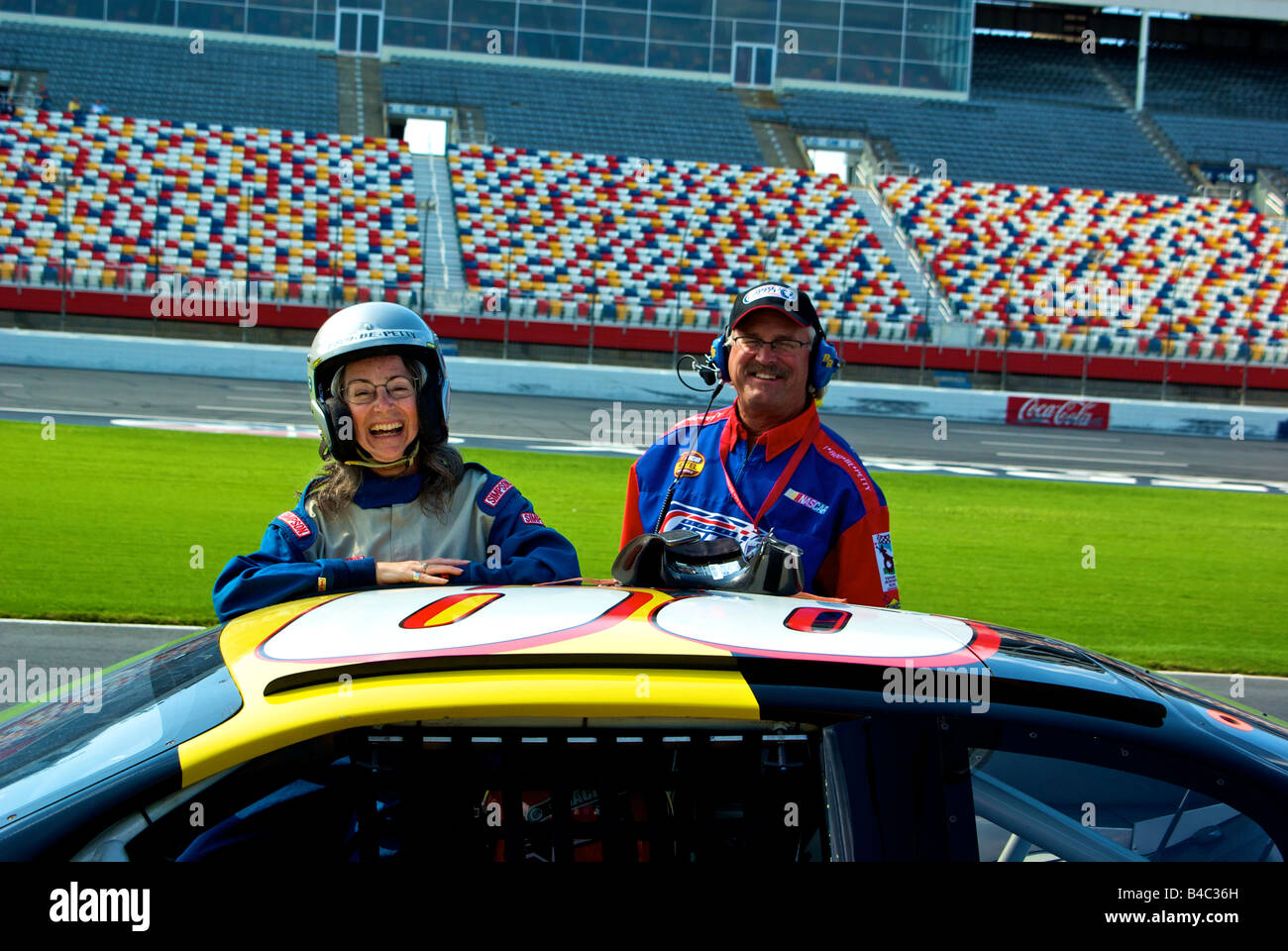 Happy woman racing fan after three hot drive along laps in a NASCAR style racecar at Lowe's Motor Speedway Stock Photo