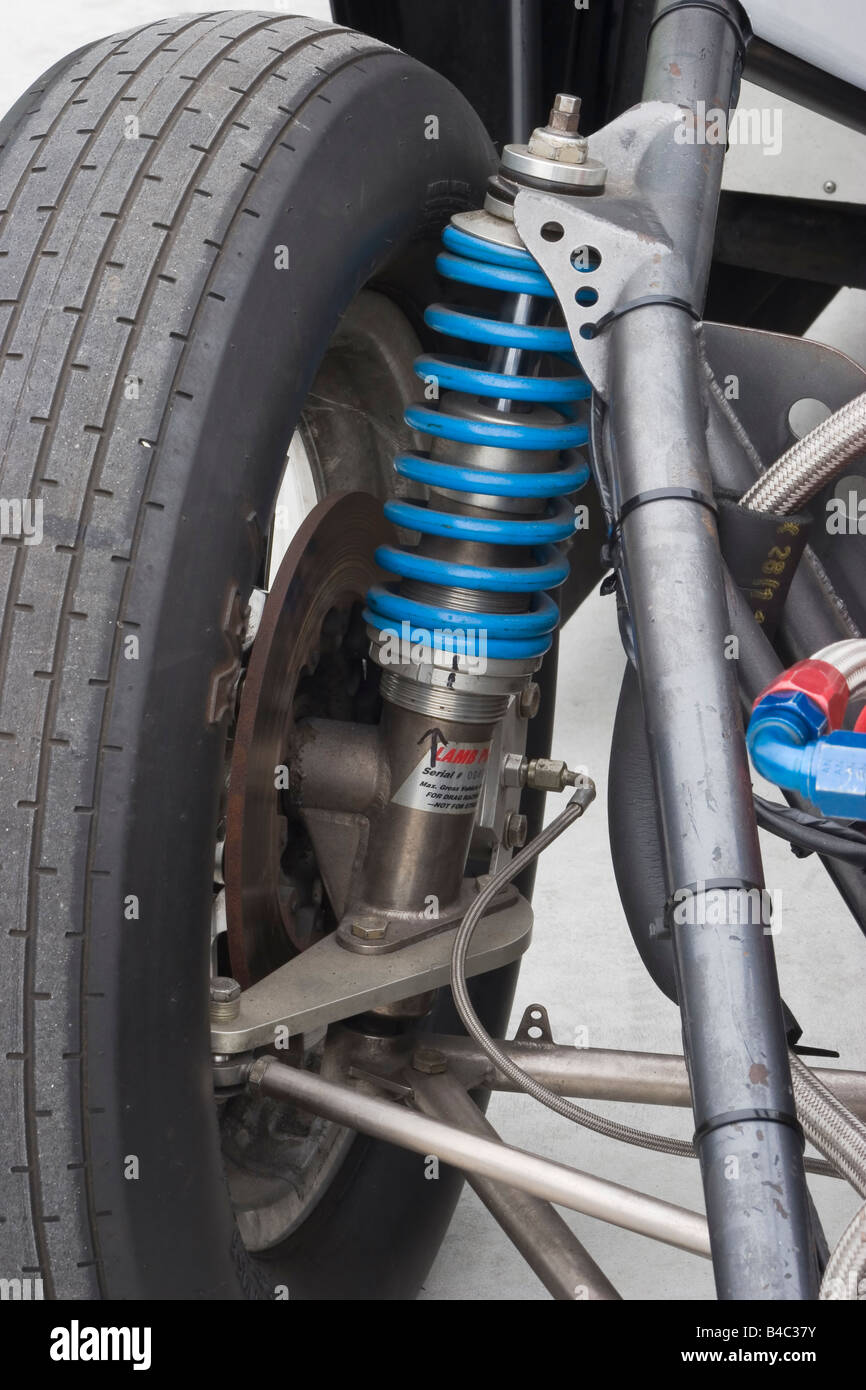 Front suspension strut with coil over spring and brake components on