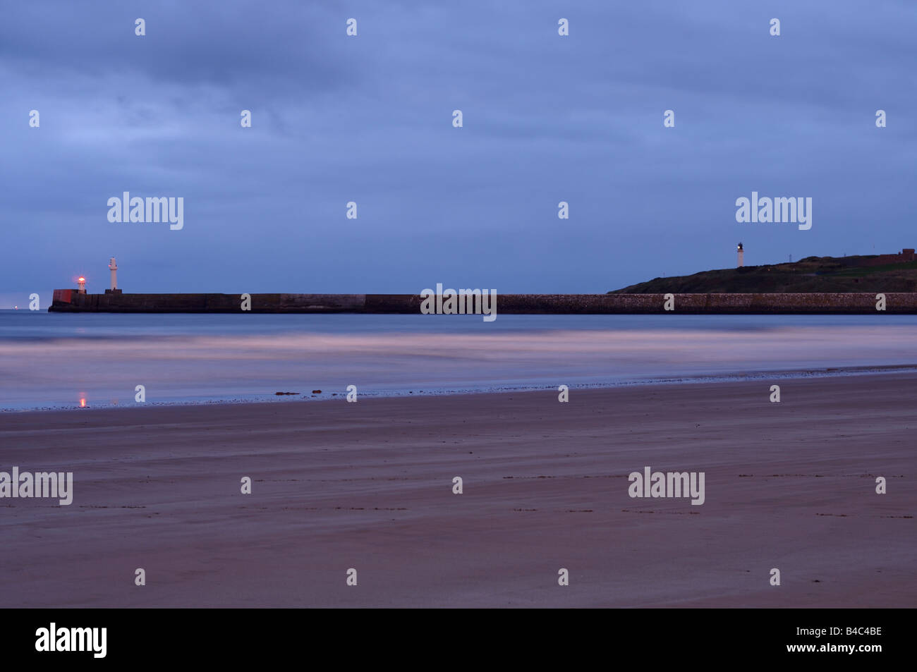 Aberdeen beach just before sunrise, looking towards the lighthouse Stock Photo