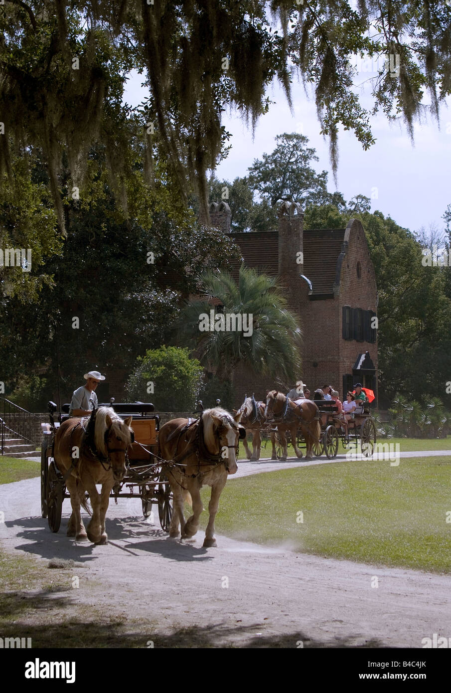 Horse drawn carriages pass the main house Middleton Place plantation in Charleston SC Stock Photo