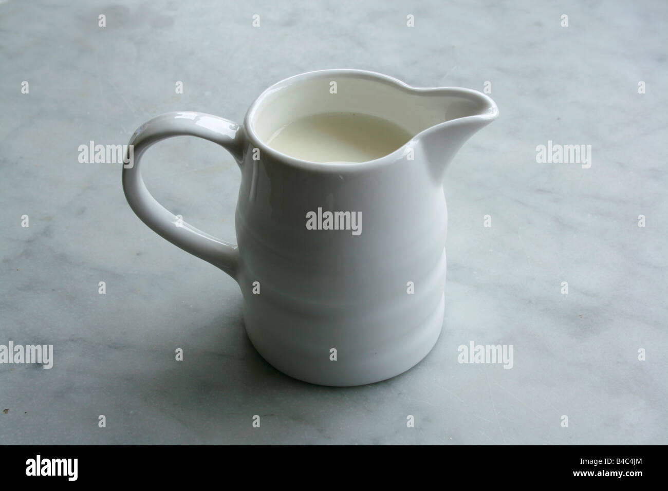 A white jug containing milk. Stock Photo