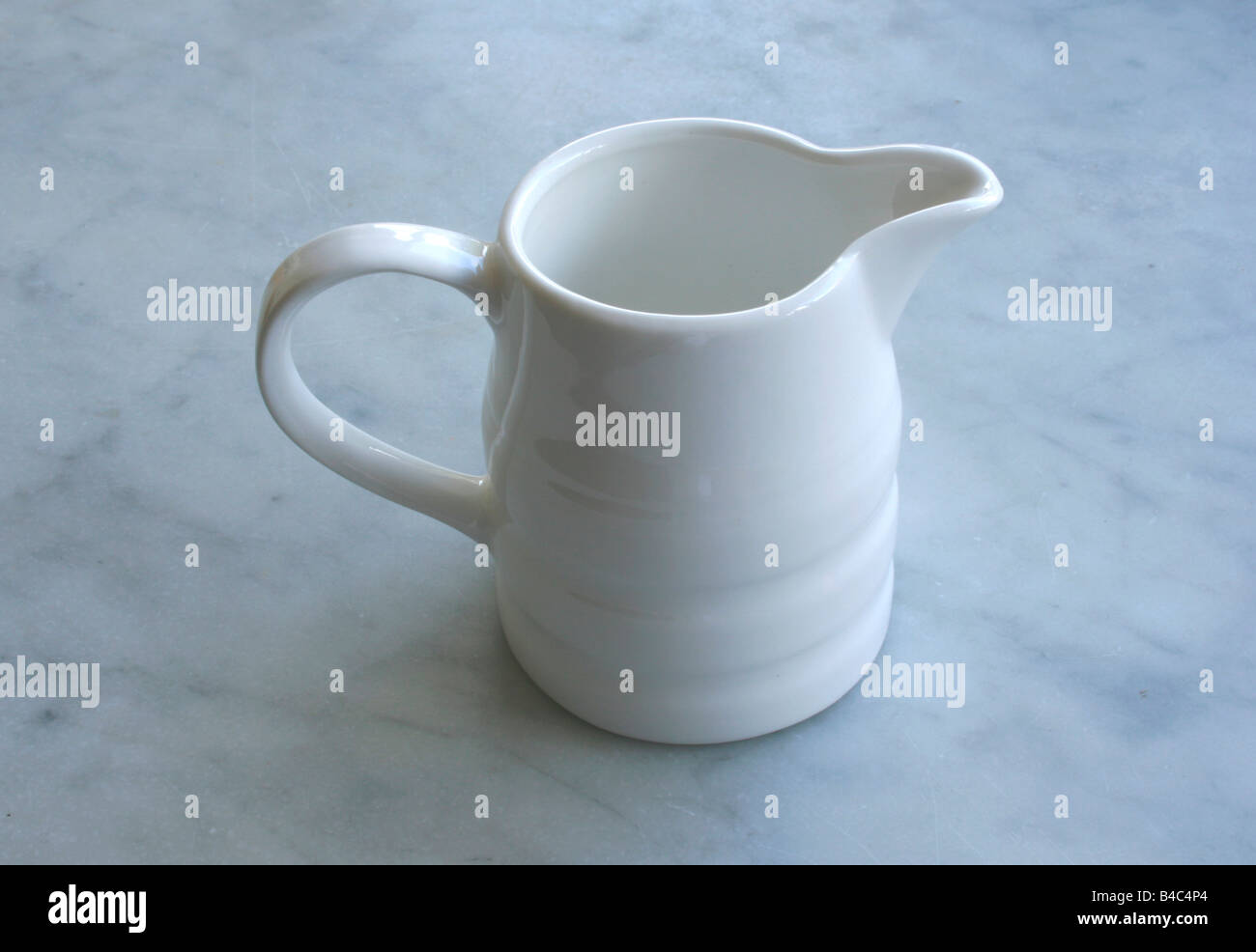 A white empty jug, on a marble worktop. Stock Photo