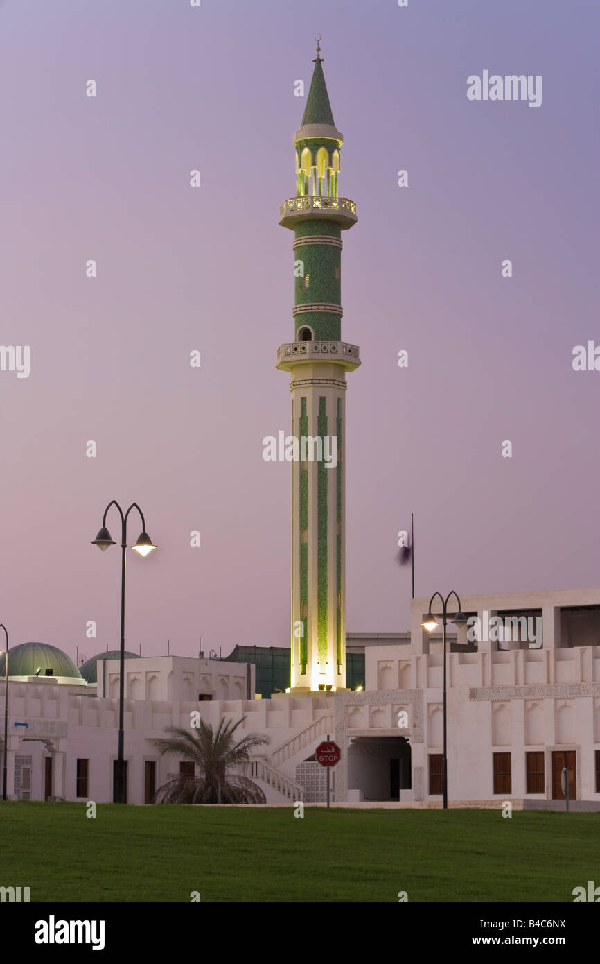 Qatar, Middle East, Arabian Peninsula, Doha, Minaret of the Grand Mosque, illuminated at dusk Stock Photo