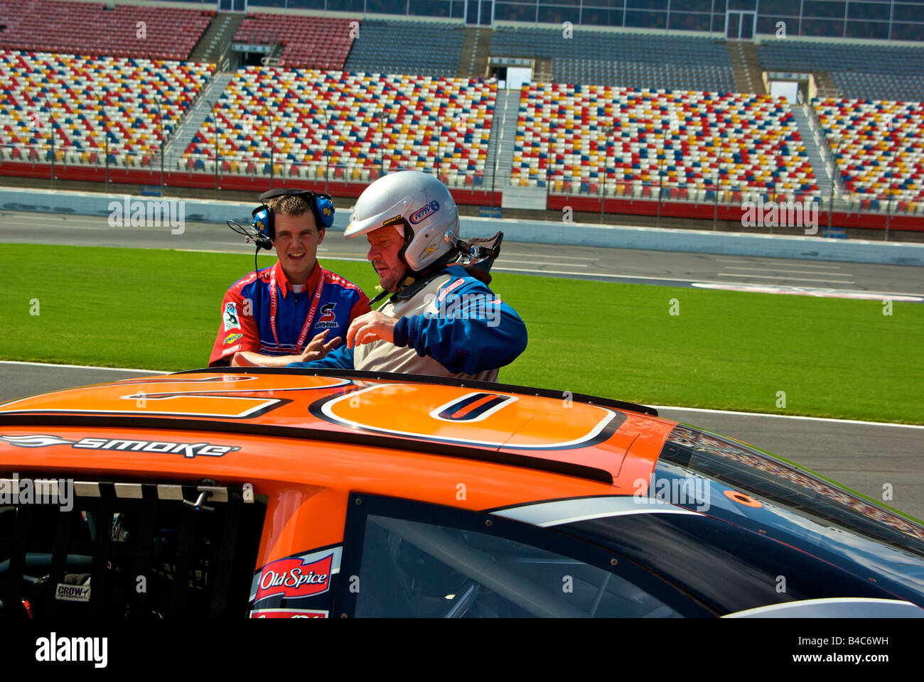 Stock car racing fan getting out after three laps riding in a Richard Petty Driving Experience NASCAR style racecar Stock Photo