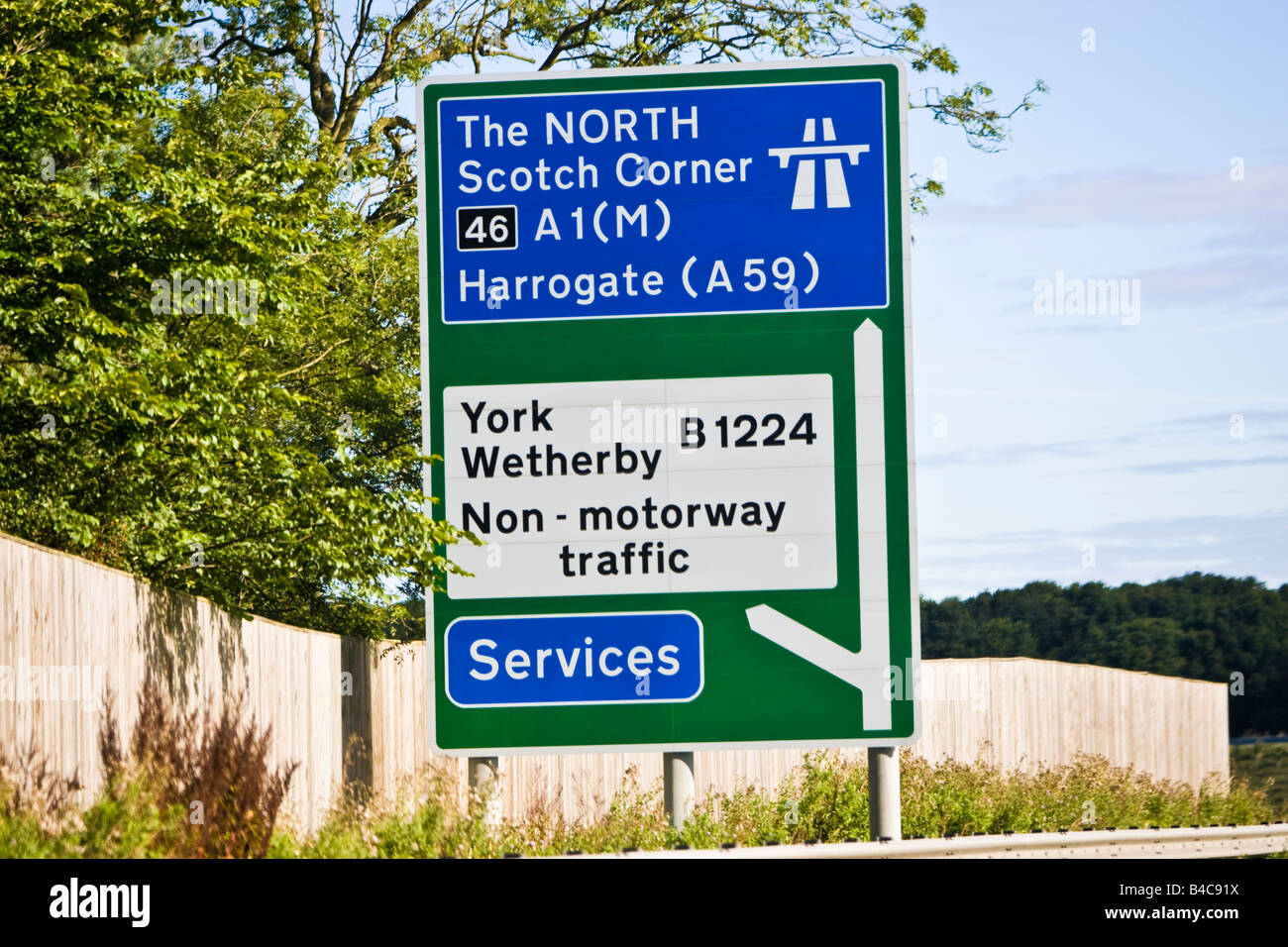 UK motorway direction and destination sign with a mix of motorway and non primary routes on a green background Stock Photo