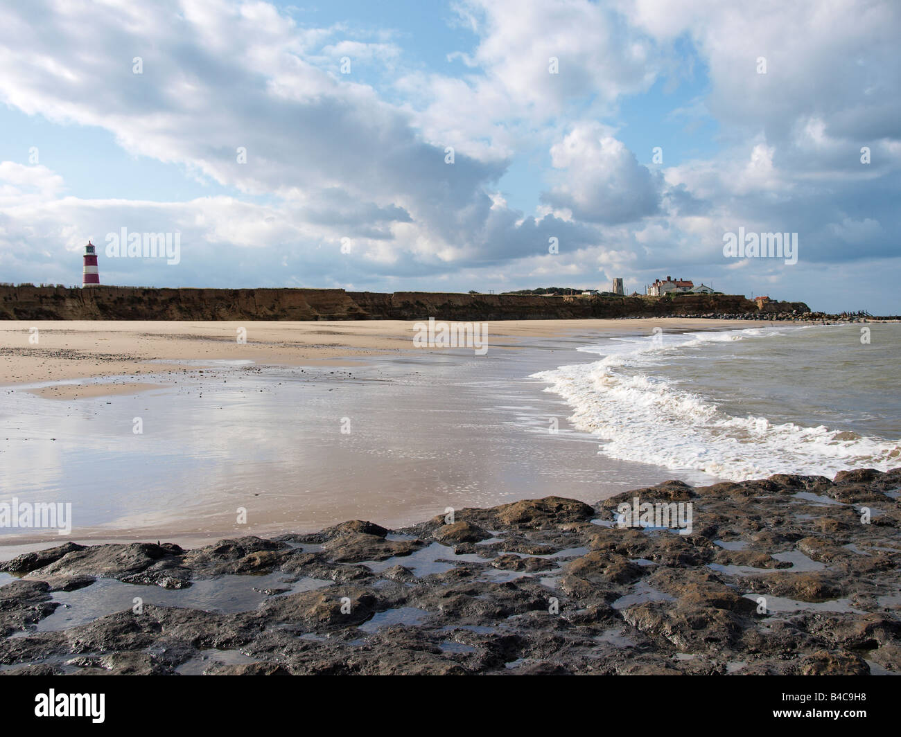 BEACH AND COAST AT LOW TIDE AT  HAPPISBURGH NORFOLK ENGLAND REVEALING SOFT BASE WHEN SAND IS REMOVED BY TIDAL ACTION. Stock Photo