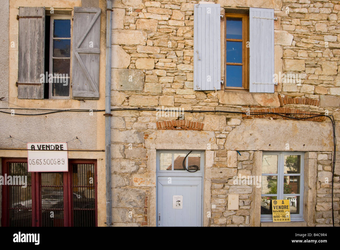 Village houses with estate agents for sale signs, Marcilhac sur Cele, 46, Lot, Quercy, France, Europe Stock Photo