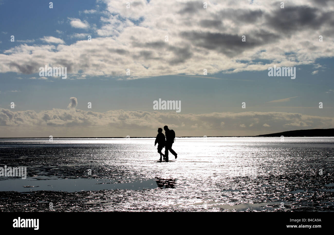 Walkers crossing Morecambe Bay, Arnside, Cumbria Stock Photo