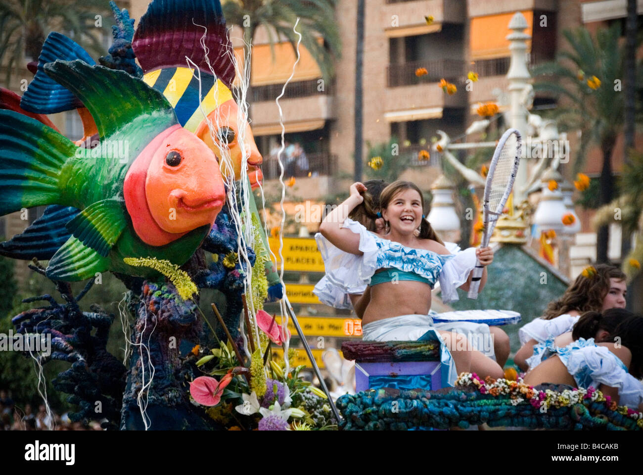 Spanish girl in costume on a float during the Battle of Flowers or