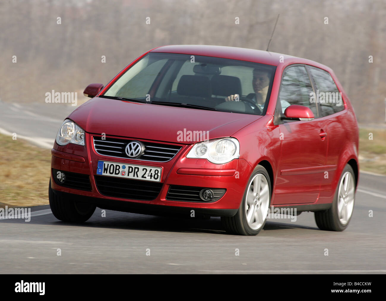 Car, VW Volkswagen Polo 1.4 TDI, model year 2005-, ruby colored, small  approx., Limousine, driving, diagonal from the front, fro Stock Photo -  Alamy