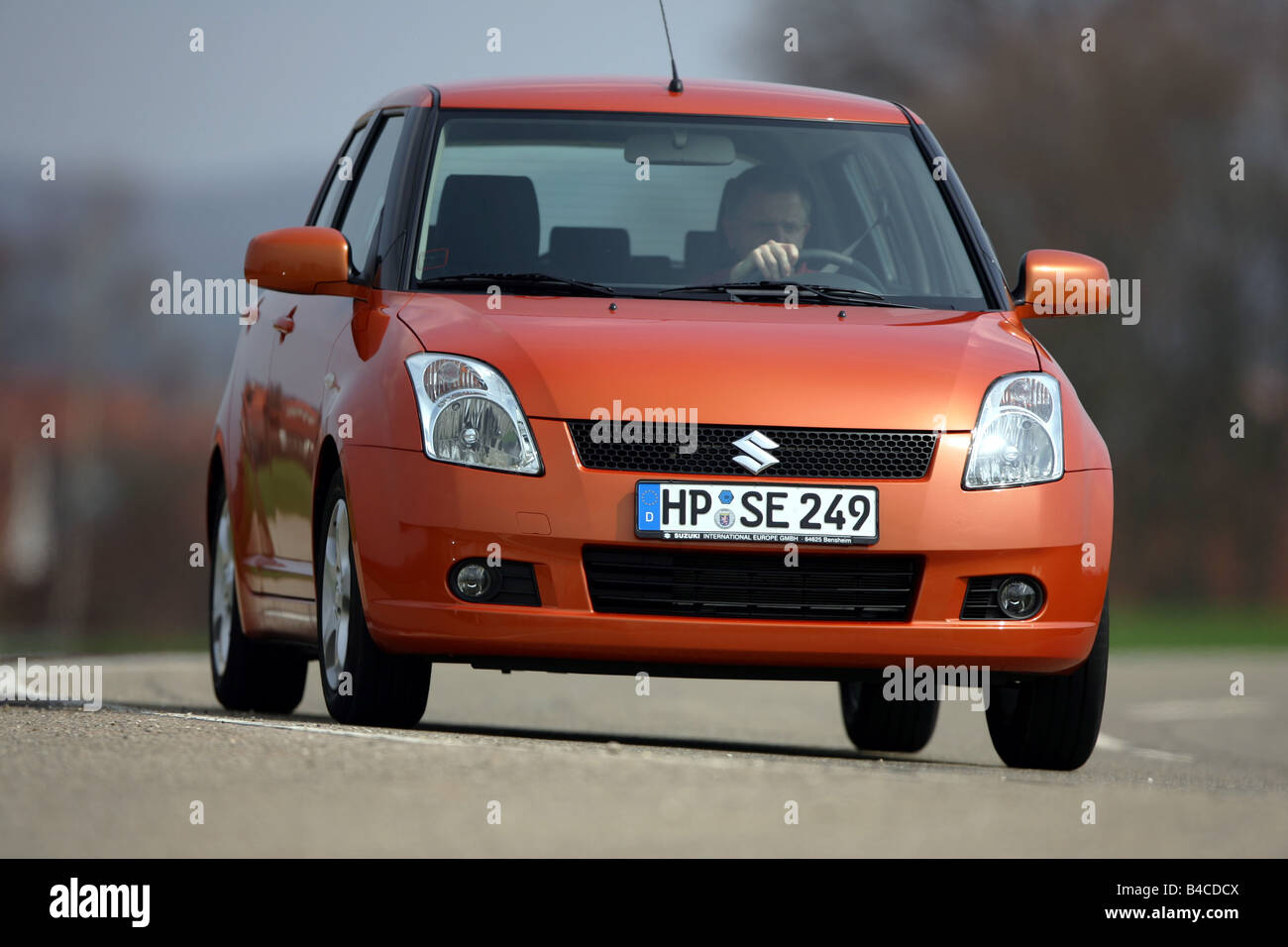 Car, Suzuki Swift 1.3, model year 2005-, orange , Limousine, small approx., driving, diagonal from the front, frontal view, coun Stock Photo