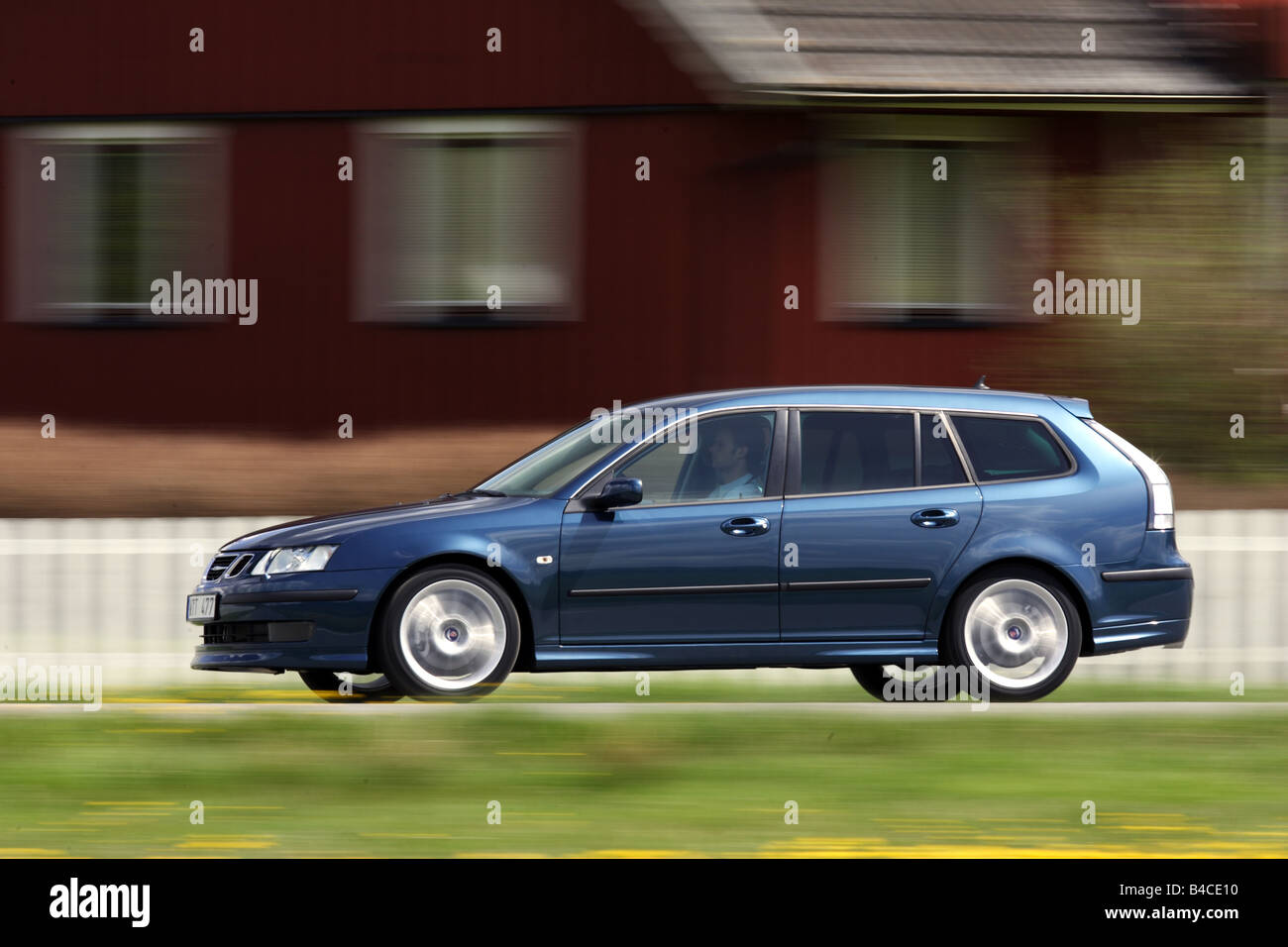 Car, Saab 9-3 Sport Combi 2.8 V6, model year 2005-, dark blue, Break combination, driving, diagonal from the front, side view, c Stock Photo