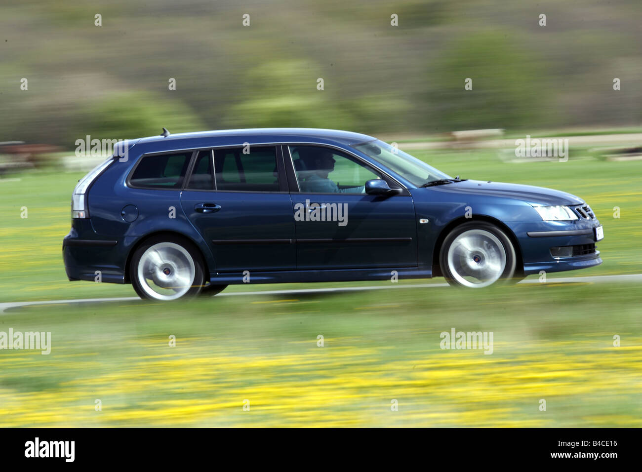 Car, Saab 9-3 Sport Combi 2.8 V6, model year 2005-, dark blue, Break combination, driving, diagonal from the front, side view, c Stock Photo