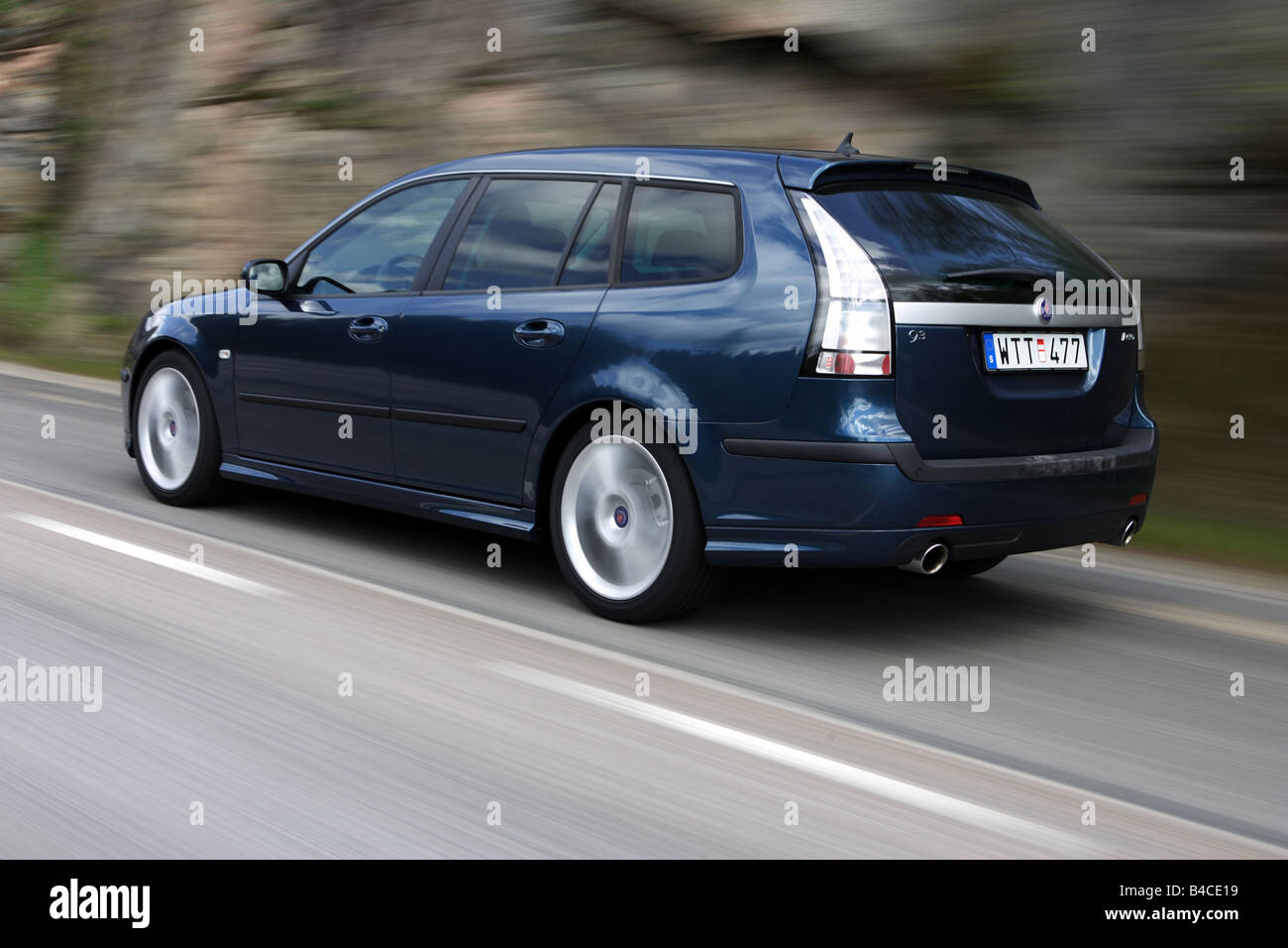 Car, Saab 9-3 Sport Combi 2.8 V6, model year 2005-, dark blue, Break combination, driving, diagonal from the back, rear view, co Stock Photo