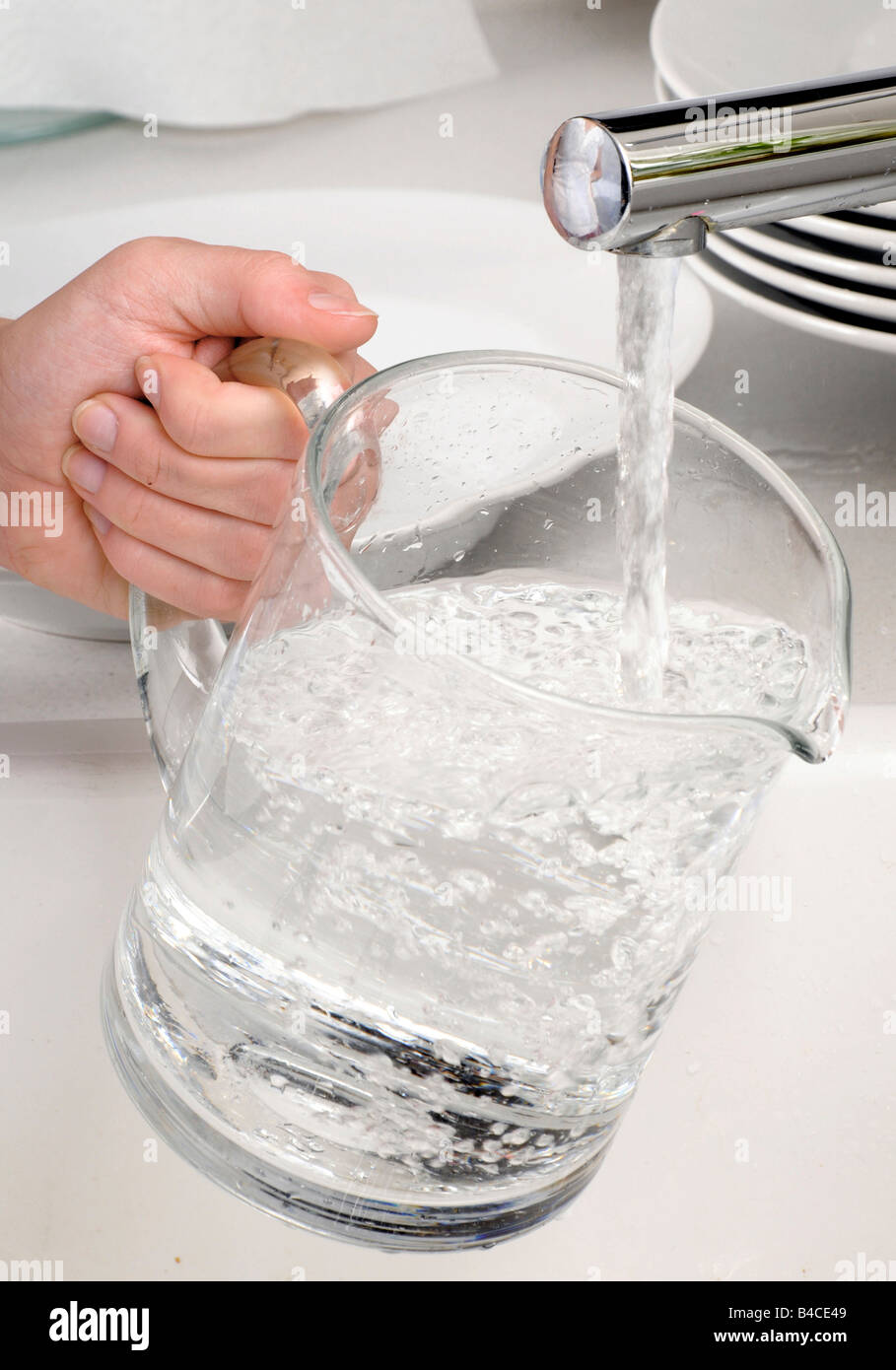 WOMAN FILLING JUG WITH TAP WATER Stock Photo Alamy