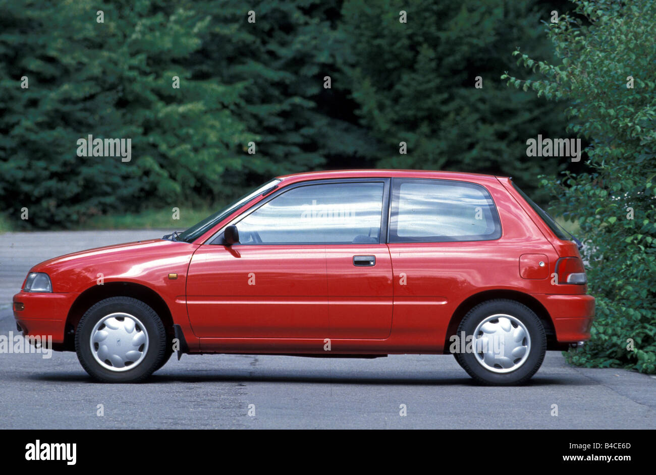 Car, Daihatsu Charade, model year 1993-, red, small approx., Limousine, standing, upholding, side view, country road, photograph Stock Photo