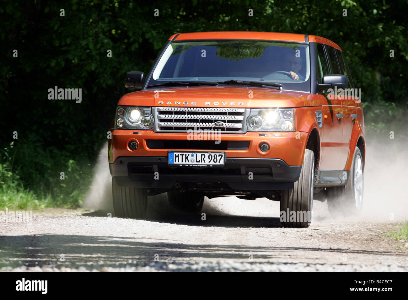 Car, Range Rover Sport V8 Supercharged, model year 2005-, orange , driving, diagonal from the front, frontal view, country road, Stock Photo