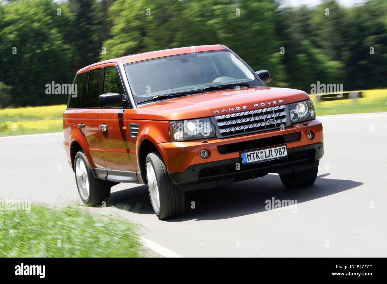 Car, Range Rover Sport V8 Supercharged, model year 2005-, orange , driving, diagonal from the front, frontal view, country road, Stock Photo