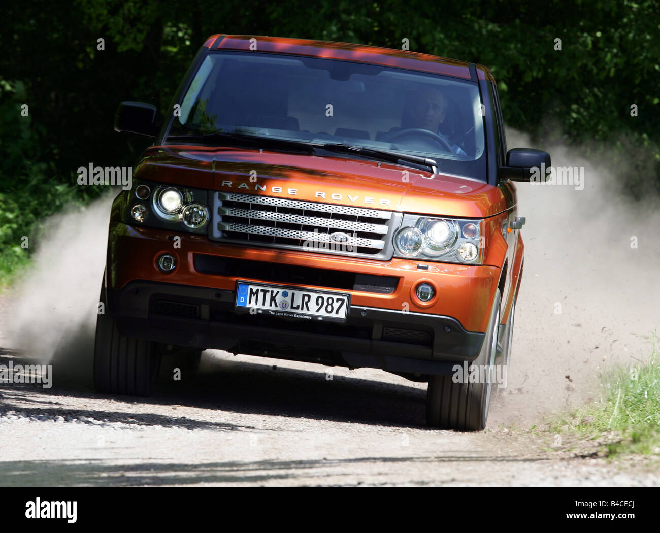 Car, Range Rover Sport V8 Supercharged, model year 2005-, orange , driving, diagonal from the front, frontal view, Dust, country Stock Photo