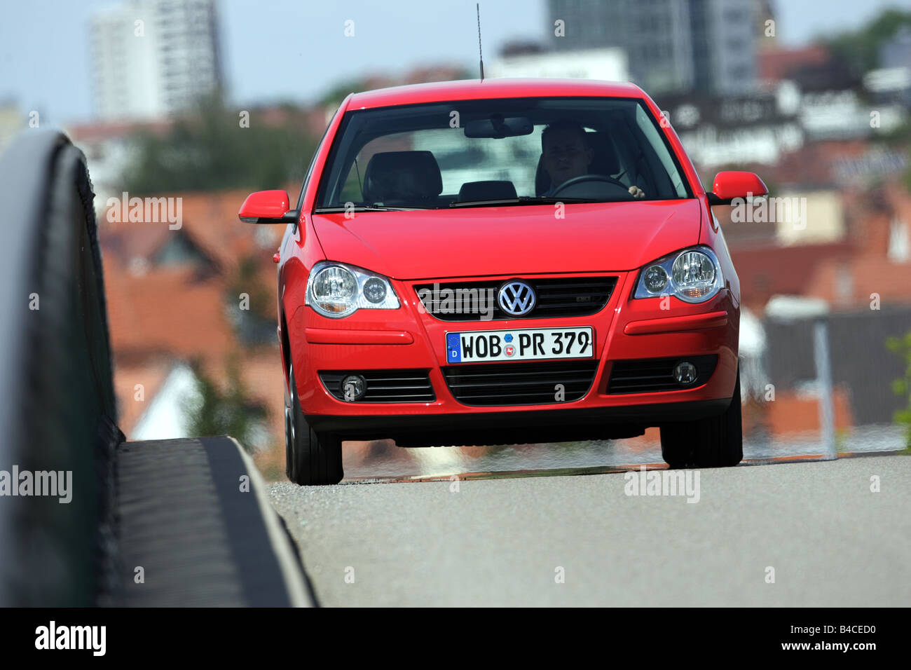 Car, VW Volkswagen Polo 1.4 TDI, model year 2005-, red, driving, diagonal  from the front, frontal view, City, photographer: Achi Stock Photo - Alamy