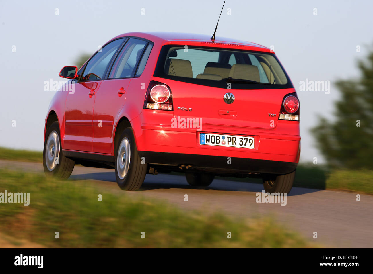 Car, VW Volkswagen Polo 1.4 TDI, model year 2005-, red, driving, diagonal  from the back, rear view, country road, photographer Stock Photo - Alamy