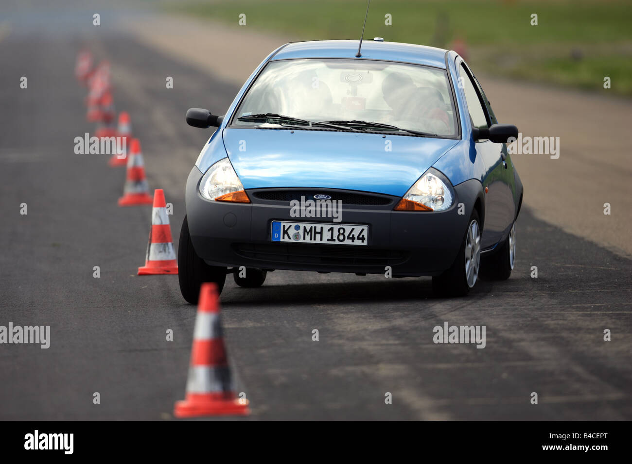 Car, Ford Ka Student, blue, model year 2004-, driving, diagonal from the front, frontal view, test track, Pilonen, photographer: Stock Photo