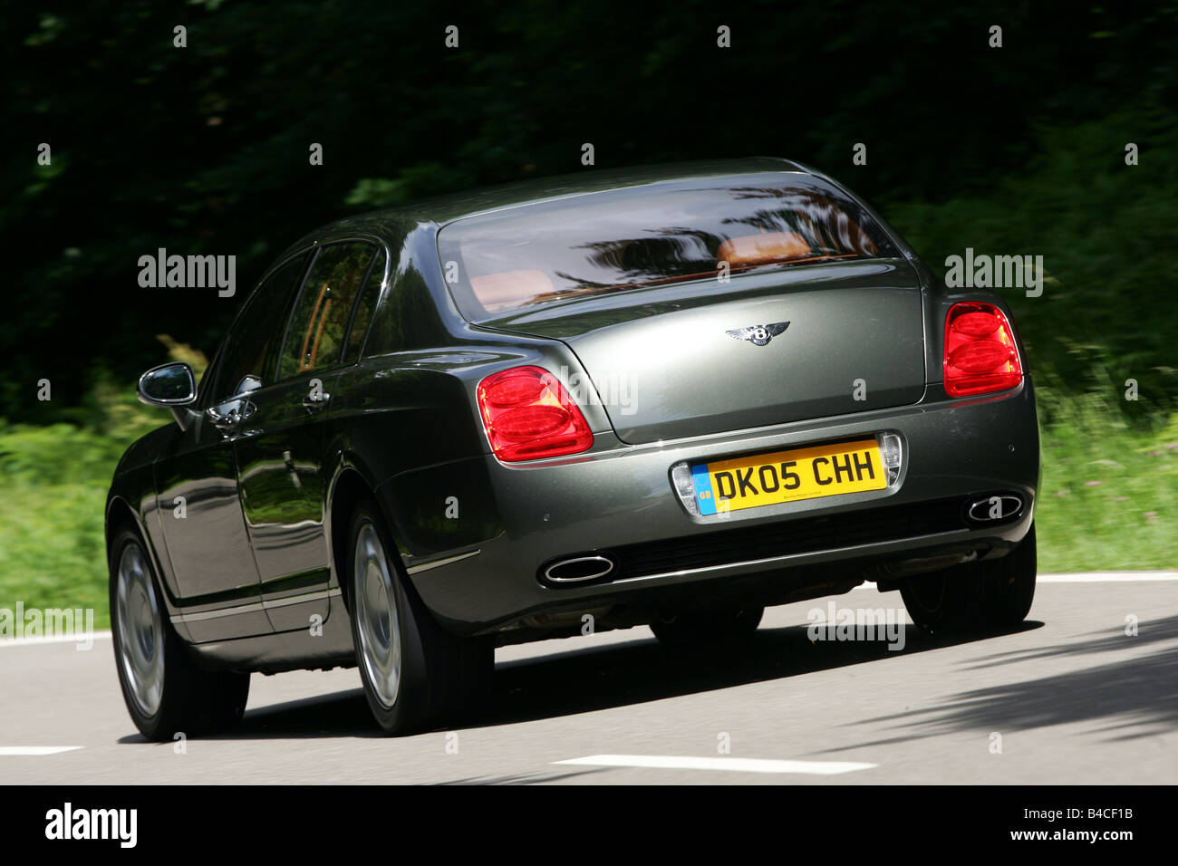 Car, Bentley Continental Flying Spur, anthracite, model year 2005-, driving, diagonal from the back, rear view, country road, ph Stock Photo