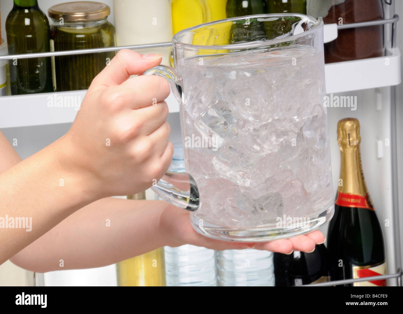 PUTTING JUG OF ICED WATER IN FRIDGE Stock Photo Alamy