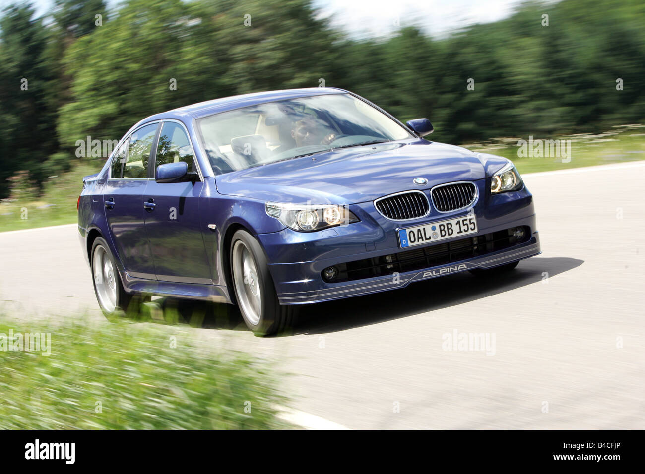 BMW Alpina B5, model year 2005-, dunkelblue moving, diagonal from the front, frontal view, country road Stock Photo