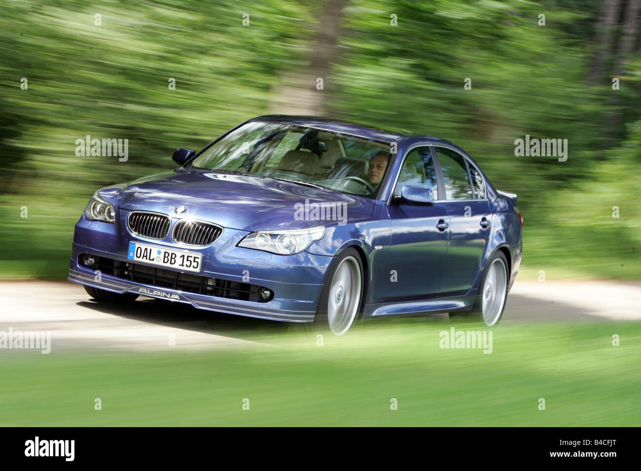 BMW Alpina B5, model year 2005-, dunkelblue moving, diagonal from the front, frontal view, country road Stock Photo