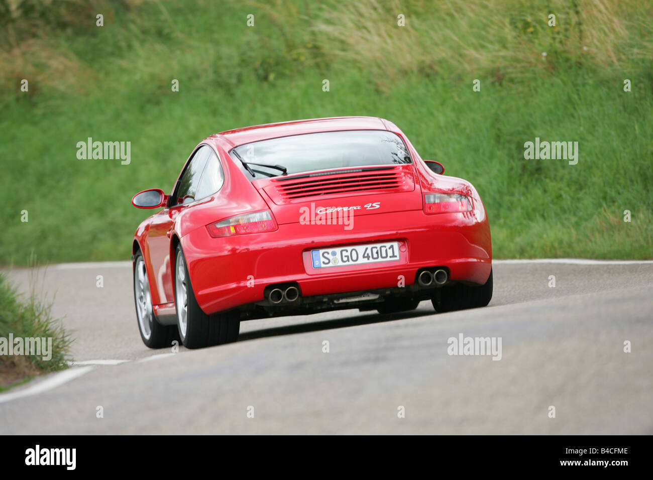 Porsche 911 Carrera 4S, model year 2005-, red, driving, diagonal from the  back, rear view, country road Stock Photo - Alamy