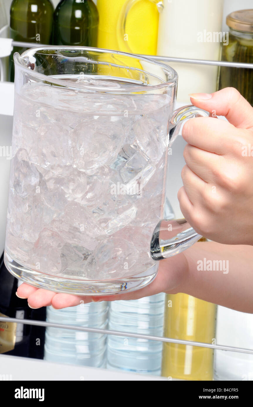 PUTTING JUG OF ICED WATER IN FRIDGE Stock Photo Alamy