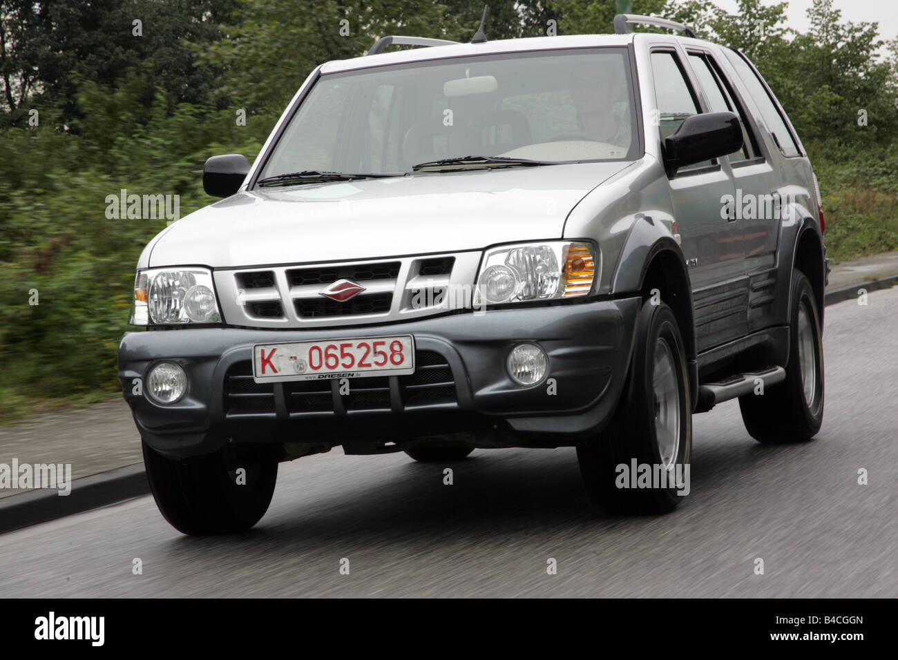 Car, Land breeze, cross country vehicle, model year 2005-, silver, driving, diagonal from the front, frontal view, country road Stock Photo