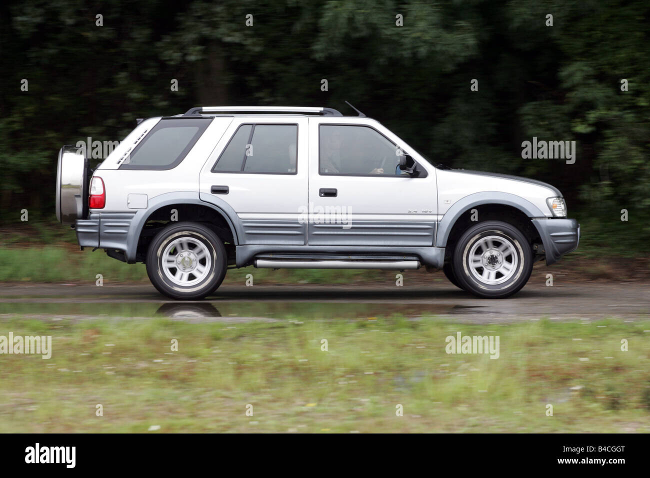 Car, Land breeze, cross country vehicle, model year 2005-, silver, driving, side view, country road Stock Photo