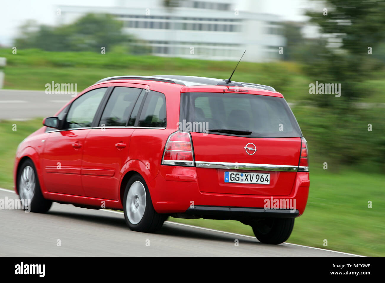 Opel Zafira 1.8 Edition , model year 2005-, red, driving, diagonal from the back, rear view, country road Stock Photo